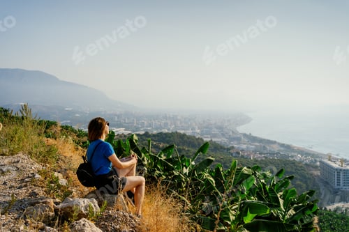 Preview: Travel - woman traveler watching the coastline, city and banana plantation