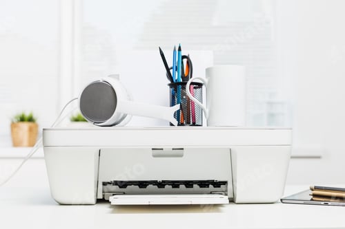 Preview: Workspace setup with a printer and office supplies by a sunlit window