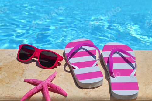 Preview: Flip flops, glasses and starfish by the poolside