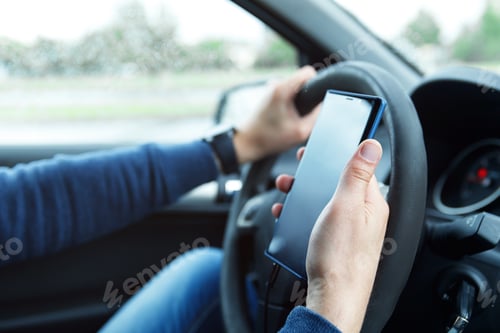 Preview: Male hands with phone. Man in car is using smartphone.