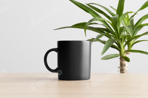 Preview: Black mug mockup on the wooden table with a yucca plant.