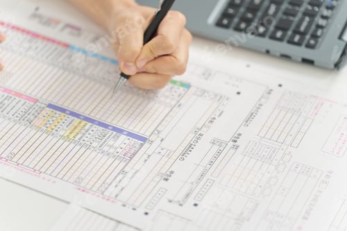 Preview: Hand of a woman filling out tax return documents,It says "tax return" in Japanese.