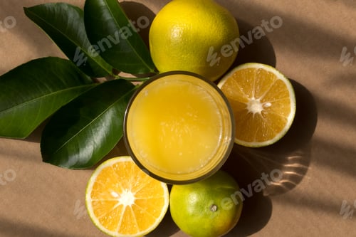 Preview: Fresh orange juice with green leaves and whole fruit