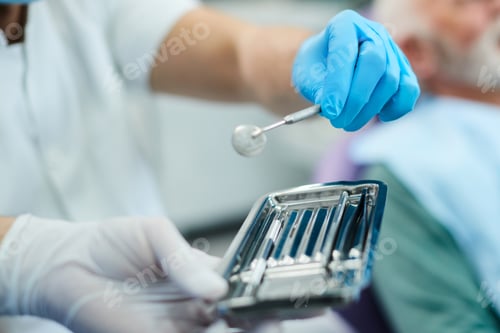 Preview: Close-up of dentist using angled mirror during dental procedure,