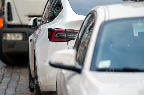 Preview: Cars parked in a row on a city street side