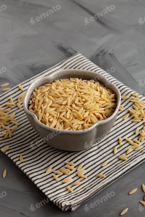 Preview: Raw Organic Orzo Pasta in a Bowl, side view.
