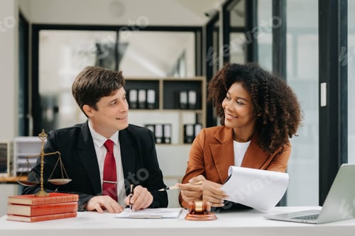 Preview: business people and lawyers discussing contract papers sitting at the table. Concepts of law