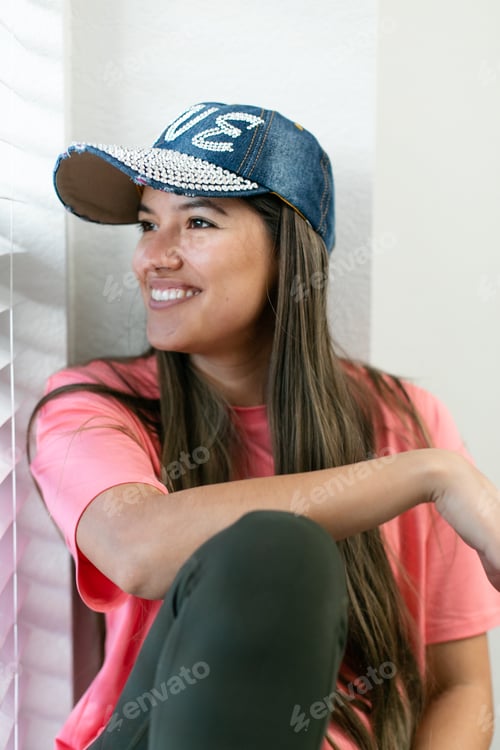 Preview: Woman smiling looking out through a window