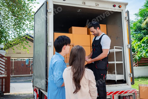 Preview: Asian Couple check while unloading boxes and furniture from a pickup truck