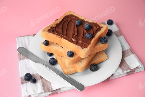 Preview: Tasty toast with chocolate paste and blueberries on pink table