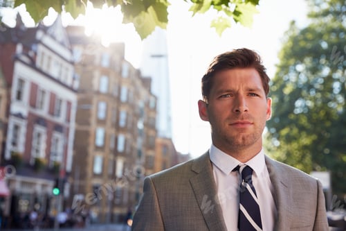 Preview: Portrait Of Businessman Walking To Work Along City Street