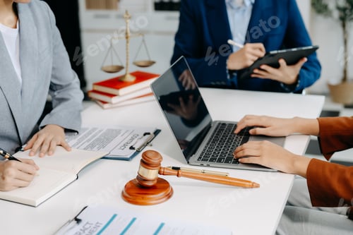Preview: business people and lawyers discussing contract papers sitting at the table.