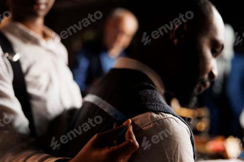 Preview: Close up of tailor taking measurements