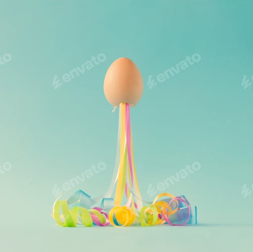 Preview: Egg with party streamers. Easter minimal concept.