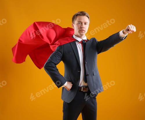 Preview: Businessman wearing superhero cape on yellow background