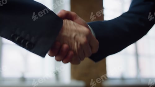 Preview: Closeup men shaking hands at office meeting. Handshaking on negotiation concept