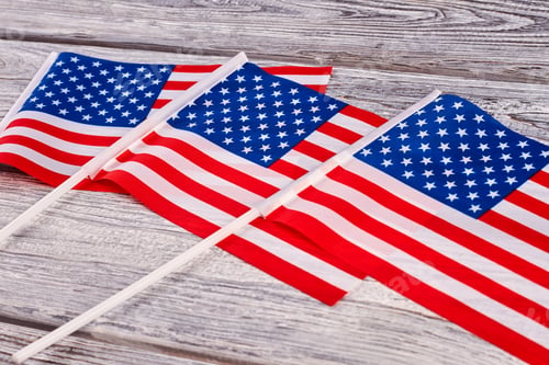 Preview: Three cocktail flags of USA on wooden background.