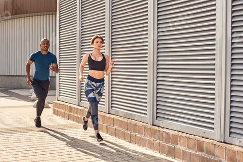 Preview: I am winning Fitness couple in sports clothing doing cardio training in the city
