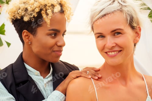 Preview: african american female groom in black suit and happy caucasian blonde b