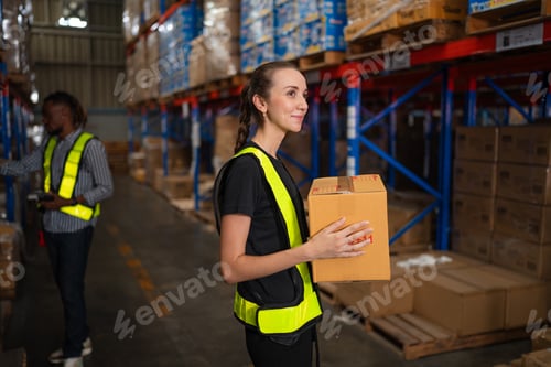 Preview: Portrait of female staff working at warehouse..