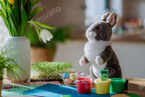 Preview: Close up of bunny soft toy with Easter decoration.