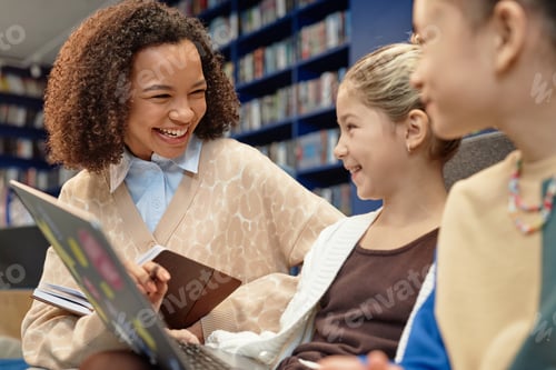 Preview: Female Teacher Helping Two Girls using Computer