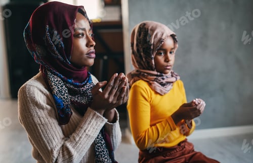 Preview: Beautiful muslim mother and child performing islamic prayers