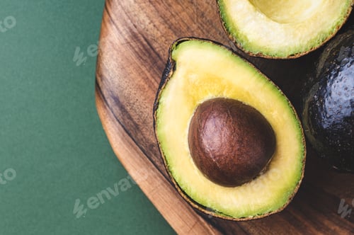 Preview: Half of Avocado Hass on Wooden Board.