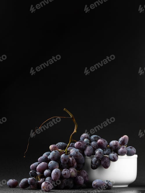 Preview: Ripe dark grapes on dark background copy space