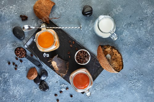 Preview: Ice coffee in Thai style with coconut milk and coffee beans on gray-blue background.