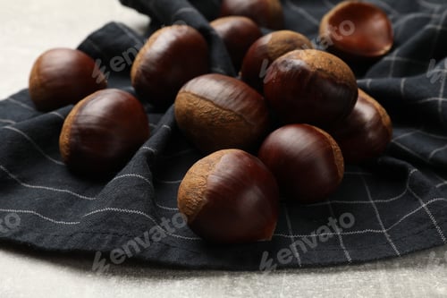 Preview: Roasted edible sweet chestnuts on light table, closeup
