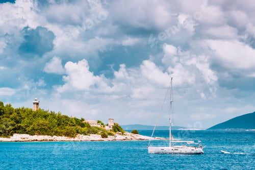 Preview: Summer holiday vacation. Port of Fiskardo. Kefalonia island, Greece. White sail boat in sea against