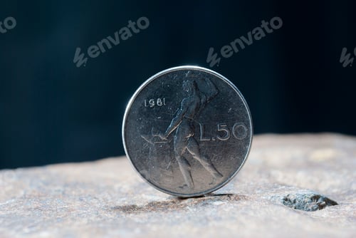 Preview: Closeup of a silver 1 Dollar 1994 Hong Kong on the rocky surface with a dark background