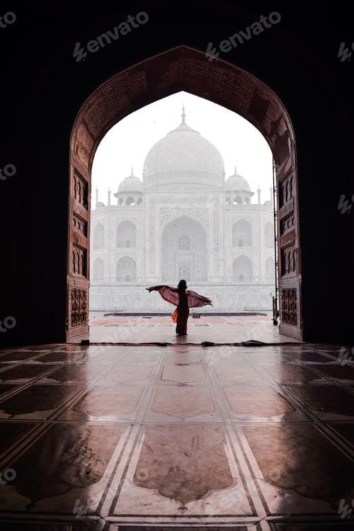 Preview: Vertical shot of a female dancing on the background of beautiful Taj Mahal in Agra, India