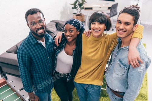 Preview: high angle view of smiling multicultural group of friends