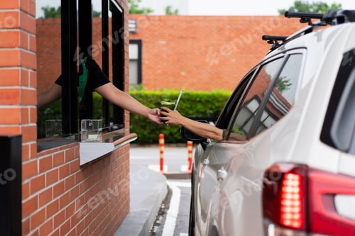 Preview: Picking up coffee or water at a drive-thru, highlighting fast service.