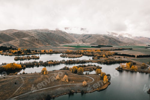 Preview: motorhome in the distance with many spaces of rivers lakes and water with lonely winding roads that
