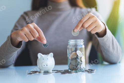 Preview: Closeup image of a woman putting coin into piggy bank and a glass jar for saving money concept