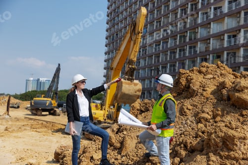 Preview: Two construction professionals, one holding blueprints and the other using a walkie-talkie