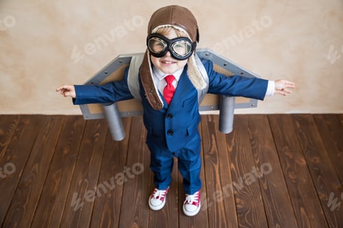 Preview: Portrait of young businessman with toy paper wings