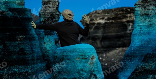 Vista previa: Blue night and alien ufo mask between rocks. Concept of aliens among us. Space discover