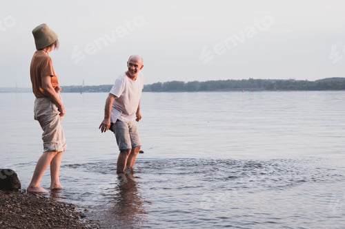 Preview: Couple of senior people having fun on river shore