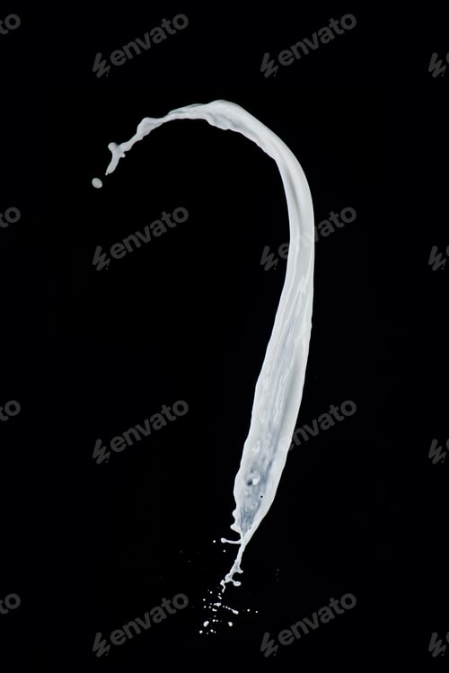 Preview: Twisted milk splash isolated on a black background. Liquid high speed photography. Food in motion.