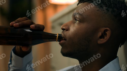 Preview: Addicted upset drunk African American depressed stress man drinking alcohol sad suffer problem drink