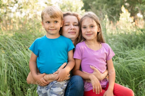 Preview: portrait of a happy family, mother, son and daughter, in nature outdoor in summer