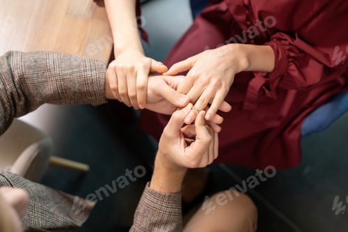 Preview: Hands of guy putting engagement ring on finger of his girlfriend during dinner