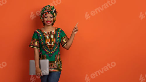 Preview: Beautiful african woman freelancer posing with laptop, copy space