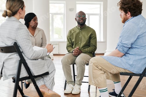 Preview: One of interracial patients describing his problem to psychologist and other people while sitting