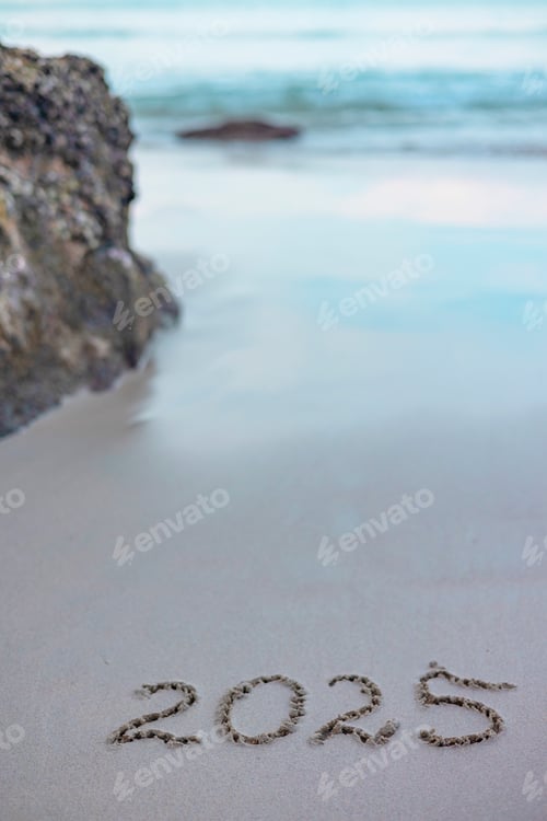 Preview: handwritten inscription 2025 on the sand by the sea
