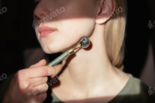 Preview: middle-aged woman with guasha massaging her face